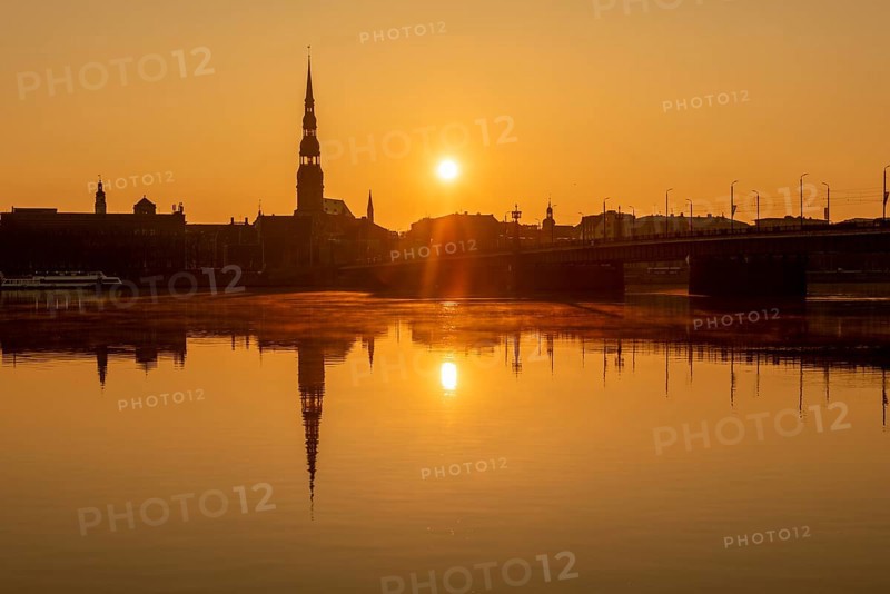 Sunrise on the Daugava River behind St Peter's Church, Riga, Latvia, Europe