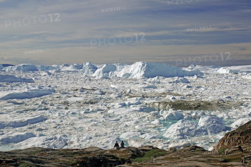 People sitting in front of fjord covered with ice and icebergs, ice fjord, Sermermuit, summer, Arctic, Ilulissat, Greenland, Denmark, North America