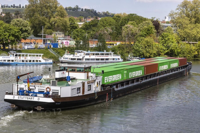Container ship travelling on the Neckar, in the background the Wilhelma landing stage, excursion boats on the Neckar, Stuttgart, Baden-Wuerttemberg, Germany, Europe