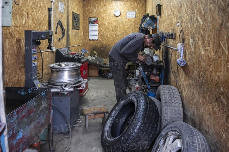 Workshop, man repairing a hole in a car tyre, Kyrgyzstan, Asia
