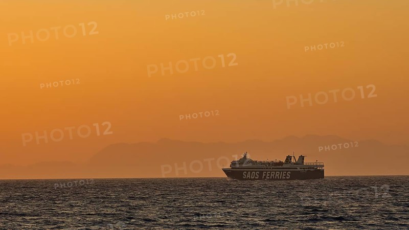 A ferry sails on the sea under a golden sunset sky, dusk, sunset, Western Promenade, Rhodes Town, Rhodes, Dodecanese, Greek Islands, Greece, Europe