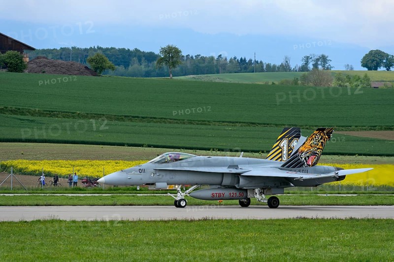Swiss Air Force squadron aircraft J-5011 of the type McDonnell Douglas FA 18C Hornet with tiger livery on the vertical stabiliser, Payerne military airfield, Payerne, Vaud, Switzerland, Europe