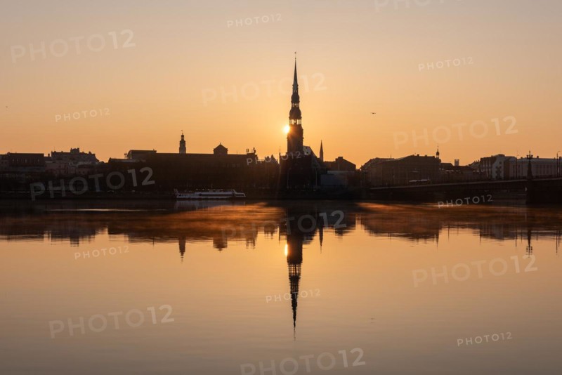 Sunrise behind St Peter's Church on the Daugava River, Riga, Latvia, Europe
