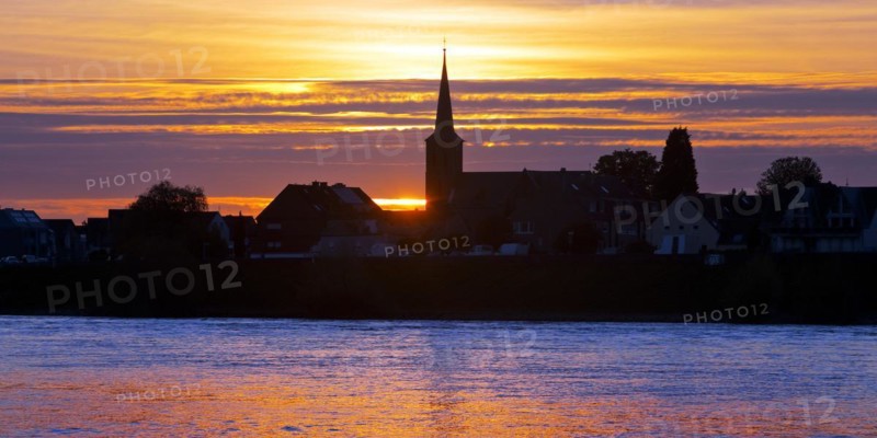 Rhine at sunset with the church of St Dionysius in Volmerswerth, Duesseldorf, Lower Rhine, North Rhine-Westphalia, Germany, Europe