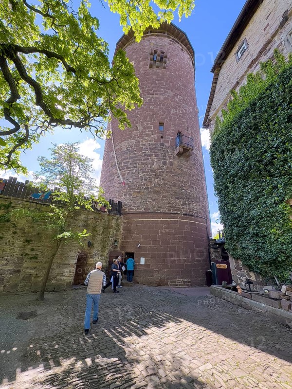 View from castle courtyard to left tower castle tower Rapunzel tower of Trendelburg Castle, right at the edge of the picture part of residential building of medieval Trendelburg from the Middle Ages 13th century castle in fairy tale fairy tale castle of Rapunzel today castle hotel Trendelburg, Trendelburg, Weserbergland, Hesse, Germany, Europe