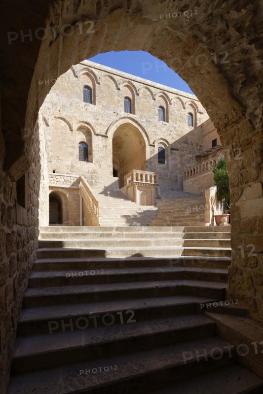 Entrance to Saint Ananias Monastery known as Deyrulzafaran or Saffron Monastery viewed through an arch, Mardin, Turkey, Asia