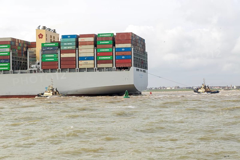 OOCL Zeebrugge container ship leaving departing from Port of Felixstowe, Suffolk, England, UK tugboats at stern