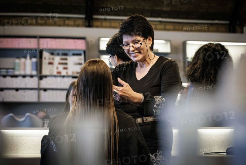 Valentyna Vysotska, hairdresser from Ukraine, bleaks her customer's hair, taken at the hairdressing salon Coiffeur Sivan in Berlin, 22/04/2024