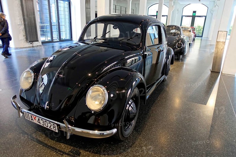 A shiny black Volkswagen Beetle parked in an exhibition hall, AUTOMUSEUM PROTOTYP, Hamburg, Hanseatic City of Hamburg, Germany Europe