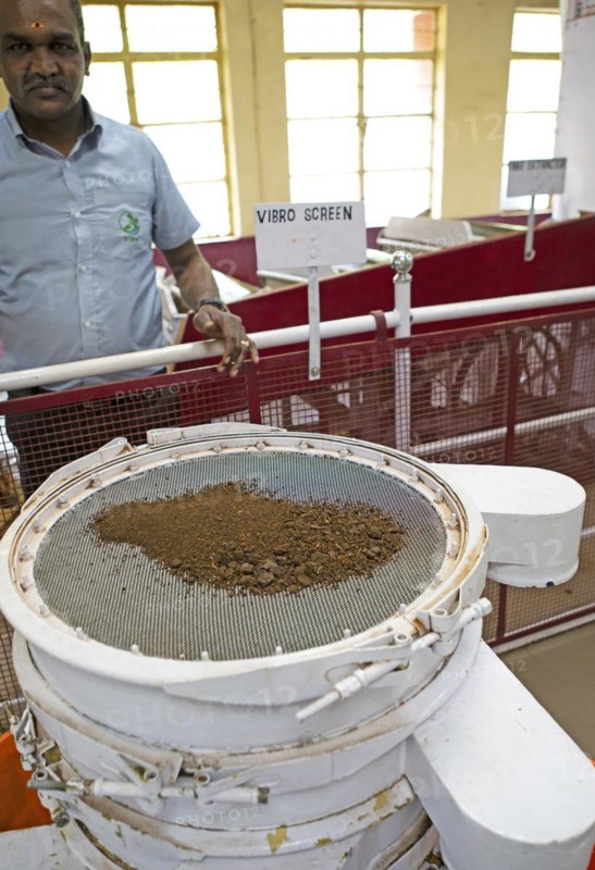 Indian man, 40 years old, showing an automatic tea strainer at the Munnar Tea Museum, Munnar, Kerala, India, Asia