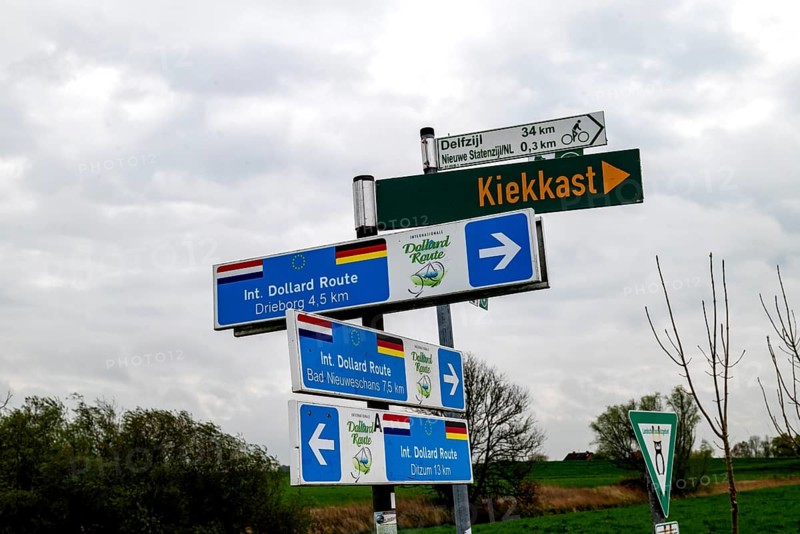 Signpost on the International Dollard Route cycle path in the border area at the Nieuwe Statenzijl lock, municipality of Oldambt, Dollart, Dollard, province of Groningen, Netherlands, German side Rheiderland, East Friesland, Lower Saxony, Germany, Europe