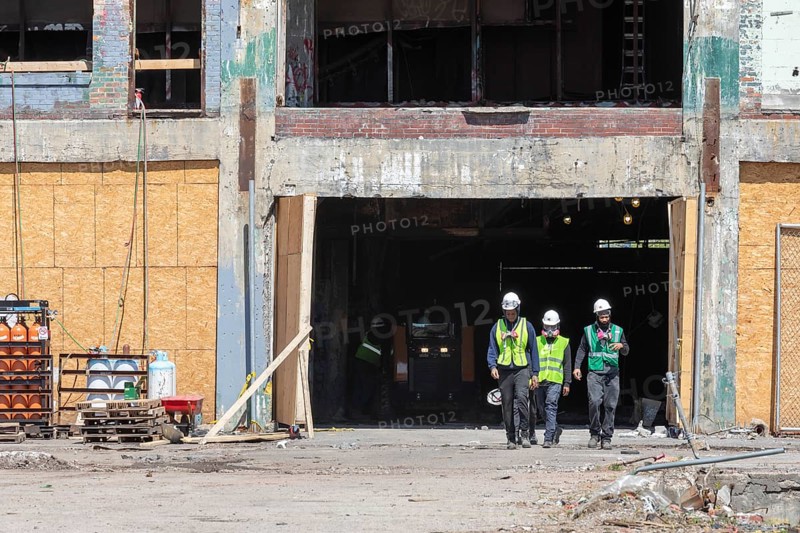 Detroit, Michigan, Workers leave the abandoned Fisher Body 21 auto factory. The building is being converted to Fisher 21 Lofts, a development of 433 apartments plus commercial space. The building opened in 1919. It was used by General Motors until 1984 and has been vacant since 1993
