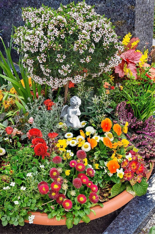 Grave with floral decoration at the cemetery church of St Stephan, Irsee, Swabia, Bavaria, Germany, Europe