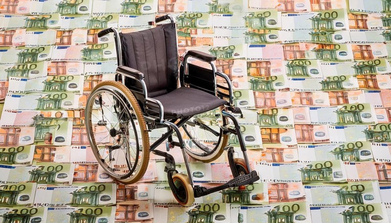 Symbolic long-term care insurance, care costs, disability, a wheelchair stands on a surface of euro notes, money, AI generated, AI generated