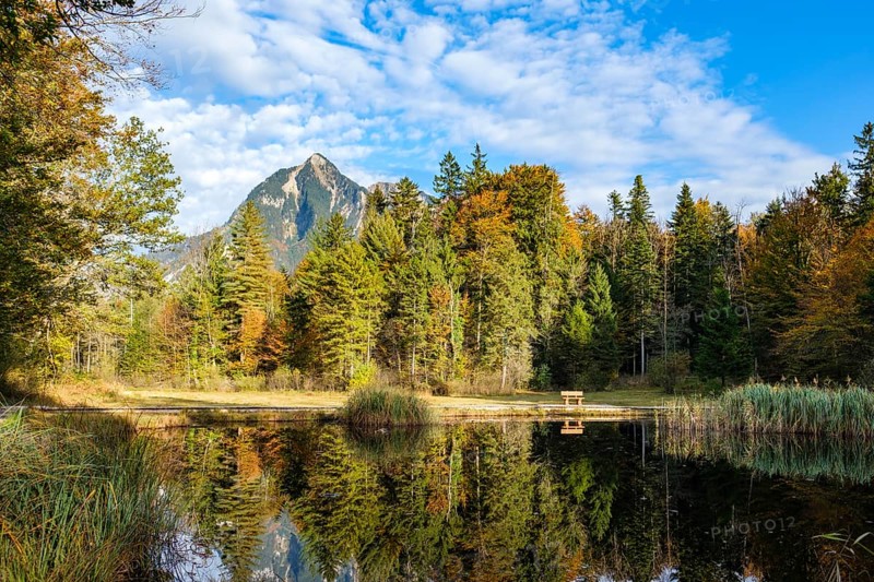 Idyllic view of a lake with reflection surrounded by autumn forest and mountains, Kernwald, Kerns, Obwalden, Switzerland, Europe