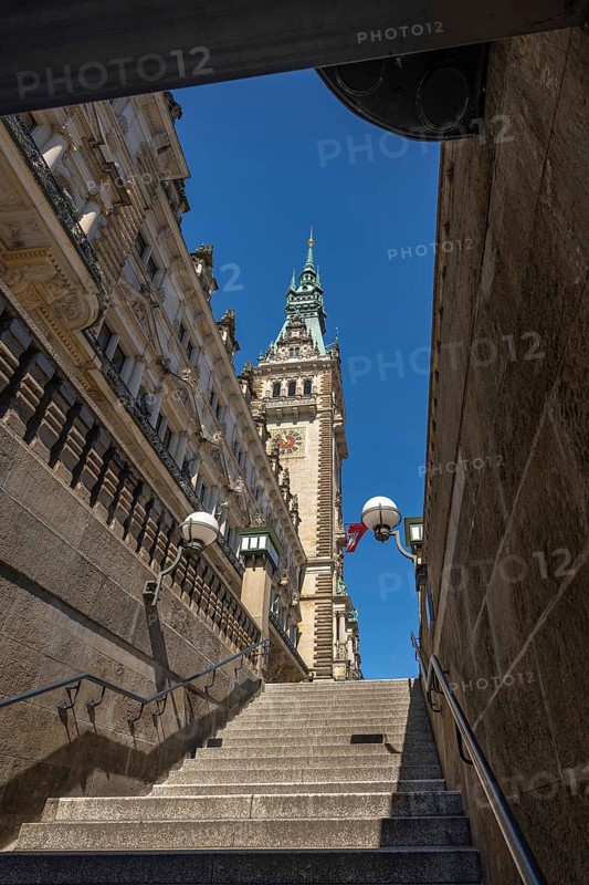 View of Hamburg City Hall through a staircase passage under a blue sky, Hamburg, Germany, Europe
