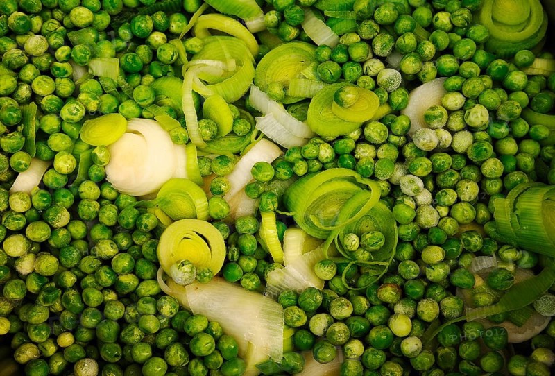 Sliced leek (Allium porrum) and green peas (Pisum sativum)