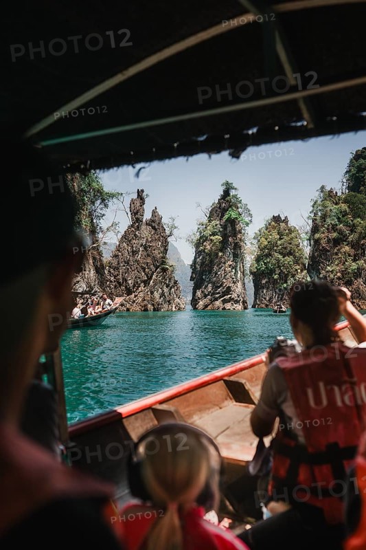 View from a boat of majestic limestone cliffs and clear water. Khao Sok National Park, Thailand, Asia
