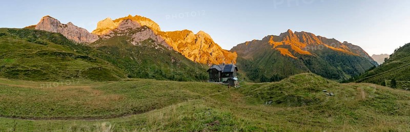 Panorama, Alpine Club hut, Hochweisssteinhaus mountain hut, mountain landscape with green mountain meadows and rocky peaks at sunrise, alpenglow, Carnic High Trail, Carnic Main Ridge, Carnic Alps, Carinthia, Austria, Europe