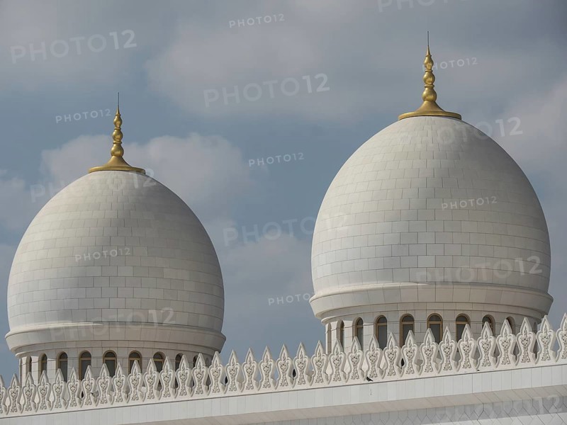 Close-up of two large white domes with golden tips under a partly cloudy sky, beautiful mosque with white domes and beautiful minarets, abu dhabi, arab emirates