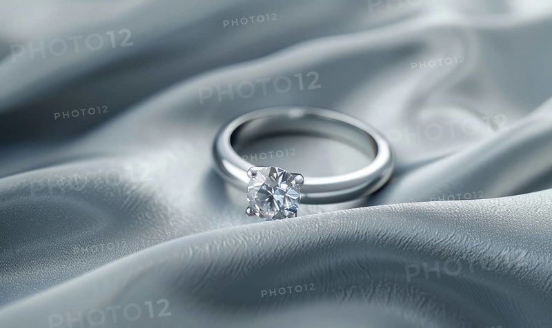 A diamond ring placed on a smooth satin material background AI generated