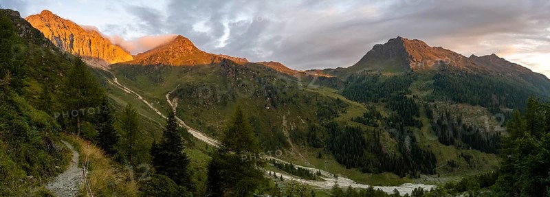 Panorama, rocky mountain peak Porze and green mountain landscape with river valley at sunrise, alpenglow, Carnic High Trail, Carnic Alps, Carinthia, Austria, Europe