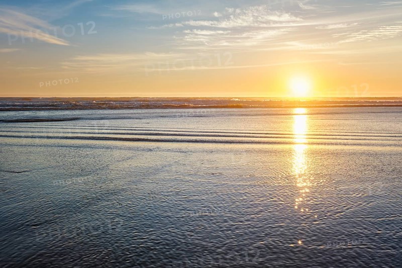 Atlantic ocean sunset with surging waves at Fonte da Telha beach, Costa da Caparica, Portugal, Europe