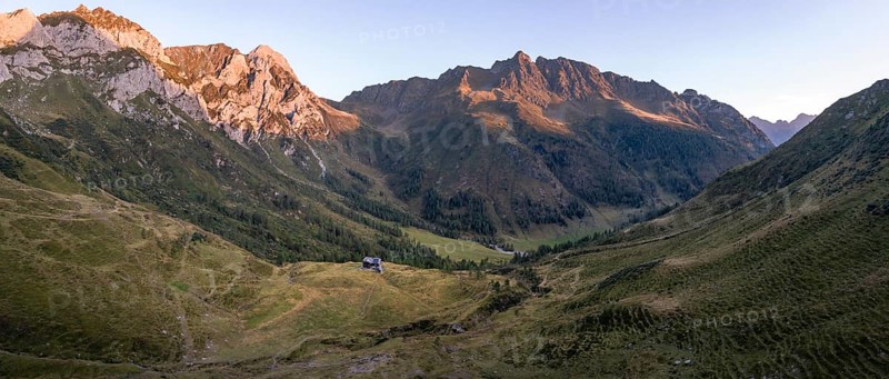 Alpine panorama, Alpine Club hut, Hochweisssteinhaus mountain hut, mountain landscape with green mountain meadows and rocky peaks at sunrise, alpenglow, Carnic High Trail, Carnic main ridge, Carnic Alps, Carinthia, Austria, Europe