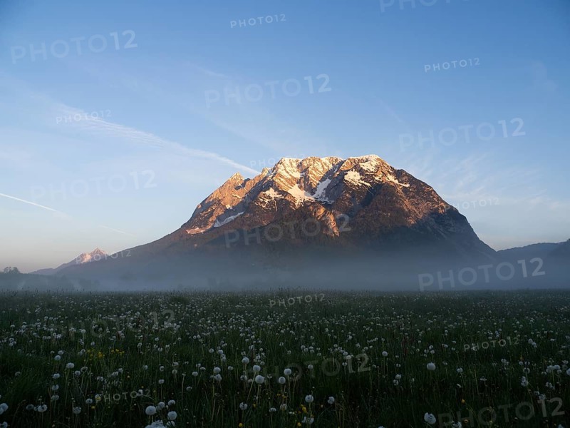 Morning light falls on a mountain peak, Grimming, early morning fog on the meadow, near Irdning, Styria, Austria, Europe
