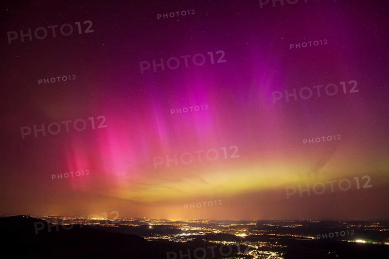 Aurora Borealis in Germany. Very strong aurora borealis over the Stuttgart metropolitan region. View from Breitenstein near Ochsenwang on the Swabian Alb, 10.05.2024. View towards Stuttgart. Teck Castle on the left