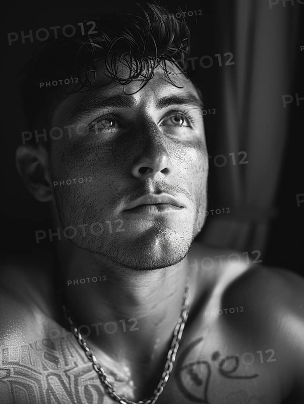 Black and white portrait of a contemplative man with tattoos, AI generated