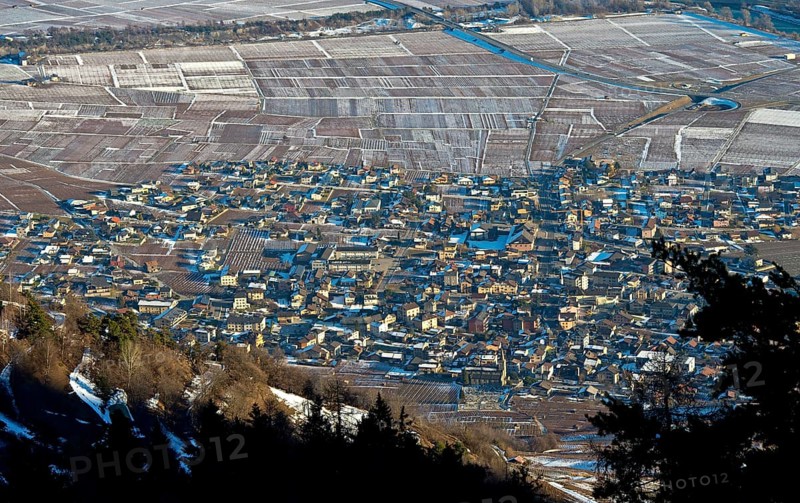 View from above of the village of Leytron in the Rhone valley with a loose open settlement structure of detached houses on the edge of vineyards in early winter, Leytron, Valais, Switzerland, Europe