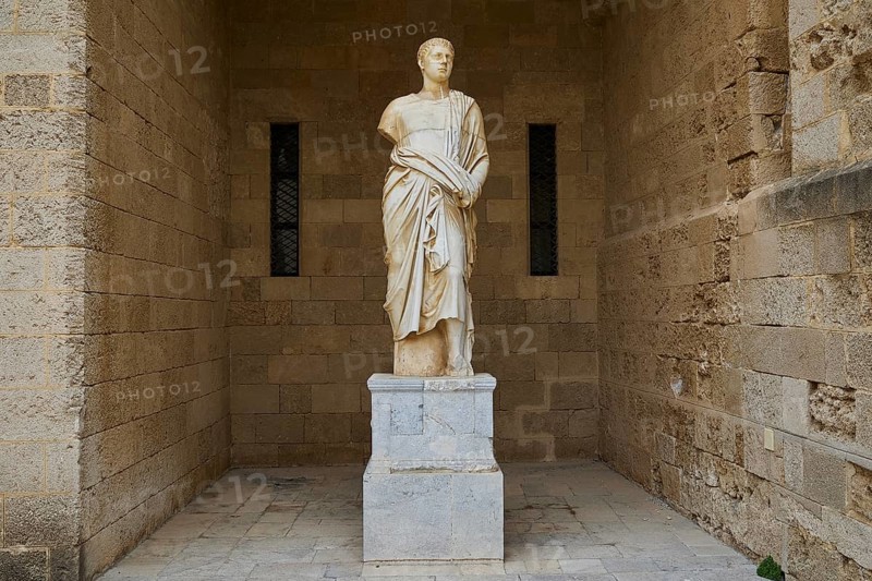 Ancient statue of a man in a long robe on a pedestal in front of a stone wall, torso from the 2nd century BC, head from the 1st century BC, courtyard, Grand Master's Palace, Knights' Town, Rhodes Town, Rhodes, Dodecanese, Greek Islands, Greece, Europe