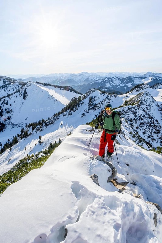 Mountaineer on the ridge of the Aiplspitz in the snow, snow-covered mountain landscape with mountain pines in winter, ski tour to the Aiplspitz, Mangfall mountains, Bavarian Prealps, Bavaria, Tyrol