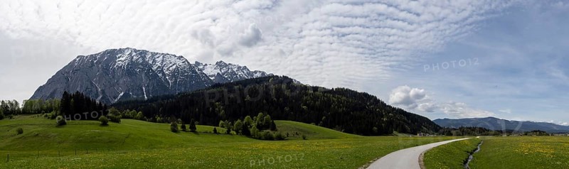 Salzkammergut cycle path leads through a meadow, cloudy mood over the Grimming, panoramic shot, near Bad Mitterndorf, Steieermark, Austria, Europe