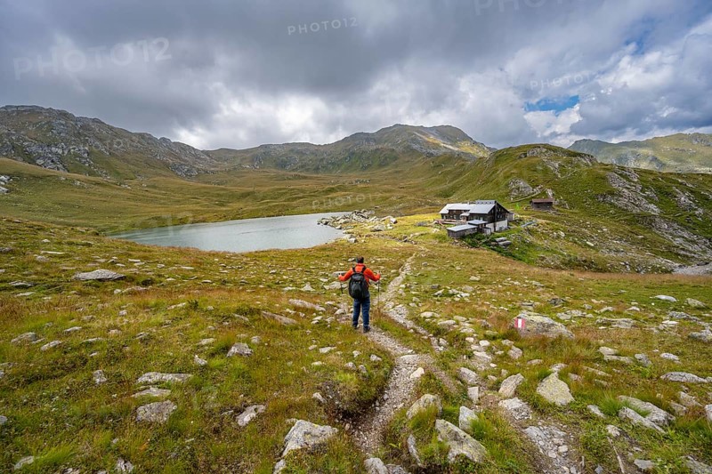 Mountaineer on a hiking trail to the mountain hut Obstanserseehuette at the mountain lake Obstansersee, Carnic Main Ridge, Carnic High Trail, Carnic Alps, Carinthia, Austria, Europe