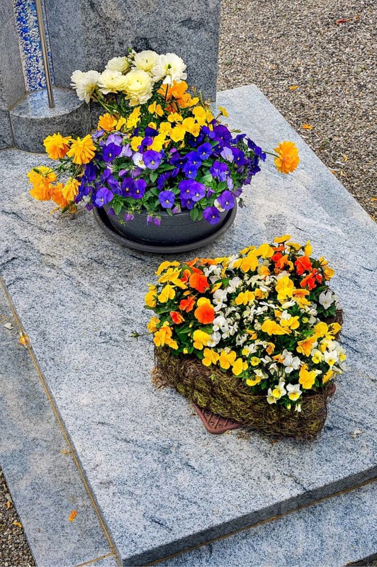 Grave with floral decoration at the cemetery church of St Stephan, Irsee, Swabia, Bavaria, Germany, Europe
