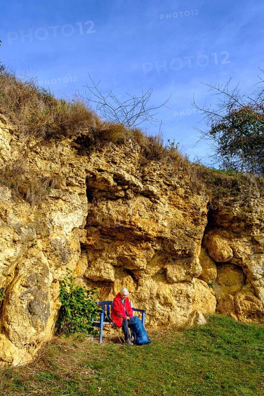 Hiker at the Burschel geotope, Riesse limestones, Hainsfarth, Ries crater rim, Noerdlinger Ries, Swabia, Bavaria, Germany, Europe