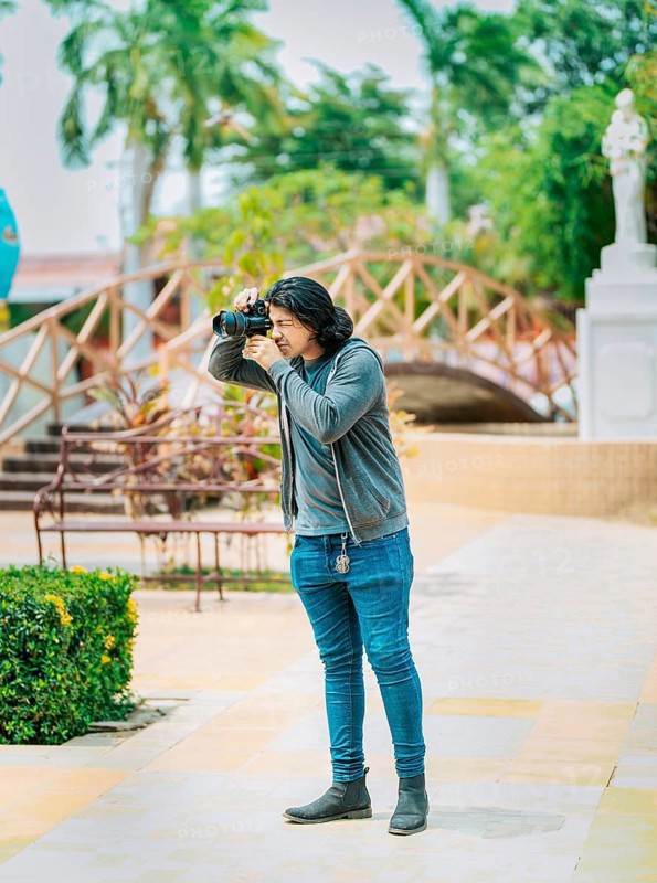 Young photographer taking photos on the street. Male photographer taking photos in a public park, Nagarote