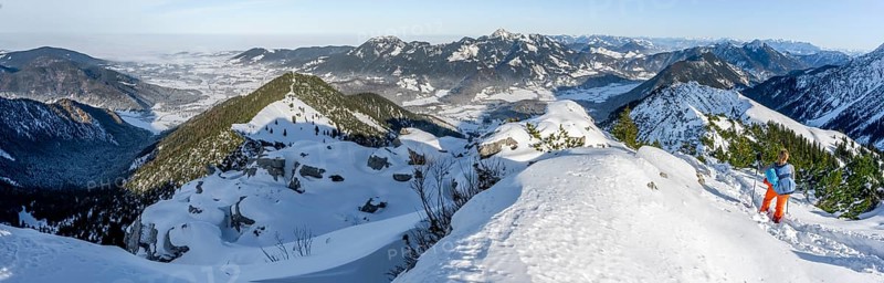 Hiker in winter climbing the Aiplspitz, winter, Alpine panorama with Aiplspitz, Schliersee and Mangfall mountains, Bavarian Prealps, Bavaria, Tyrol, Germany, Europe