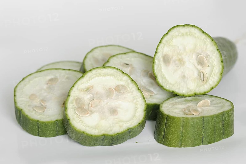 Sponge cucumber or sponge pumpkin (Luffa aegyptiaca, Luffa cylindrica), sliced fruit on a white background