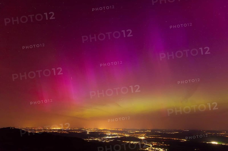 Northern lights in Germany. Very strong auroras over the Stuttgart metropolitan region. View from Breitenfels near Ochsenwang on the Swabian Alb, 10.05.2024. View towards Stuttgart, Teck Castle in the foreground