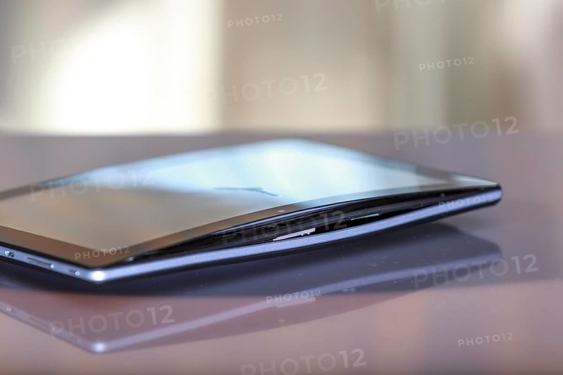 A defective, swollen battery pushes the housing of a tablet apart, damaging the display