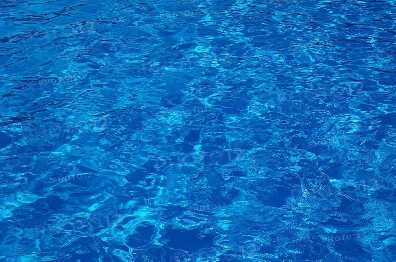 Blue, clear and undulating water in an outdoor pool