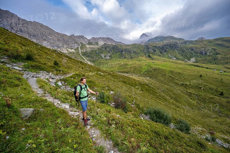 Mountaineer on a hiking trail in the upper Leitner valley, rocky mountain ridge Cresta della Pitturina in the background, Carnic High Trail, Carnic Alps, Carinthia, Austria, Europe