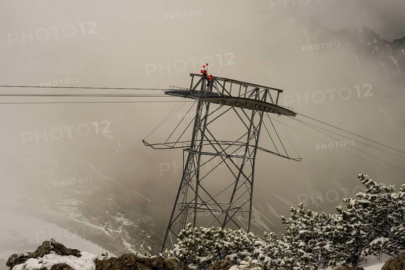 Cable car technicians working in bad weather conditions, Nebelhorn cable car near Oberstdorf, Allgaeu Alps, Allgaeu, Bavaria, Germany, Europe