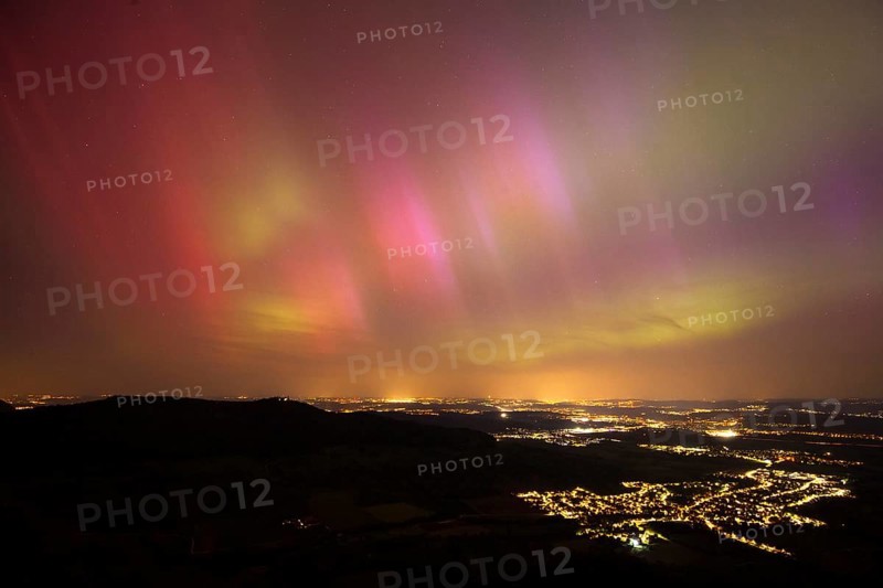 Aurora Borealis in Germany. Very strong aurora borealis over the Stuttgart metropolitan region. View from Breitenstein near Ochsenwang on the Swabian Alb, 10.05.2024. View towards Stuttgart. Teck Castle on the left