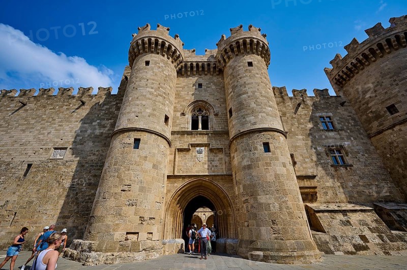Super wide angle shot, group of visitors approaching the entrance of a large castle with two round towers, main portal, Grand Master's Palace, Knights' Town, Rhodes Town, Rhodes, Dodecanese, Greek Islands, Greece, Europe