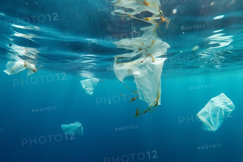 Plastic waste swimming in ocean, AI generated