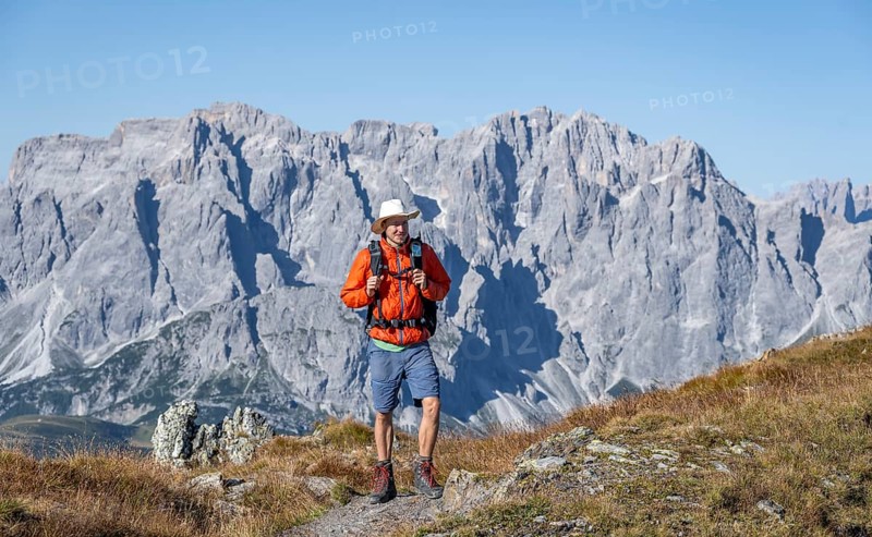 Mountaineer on hiking trail in front of rocky mountain peaks, behind Sesto Dolomites, Carnic Main Ridge, Carnic High Trail, Carnic Alps, Carinthia, Austria, Europe